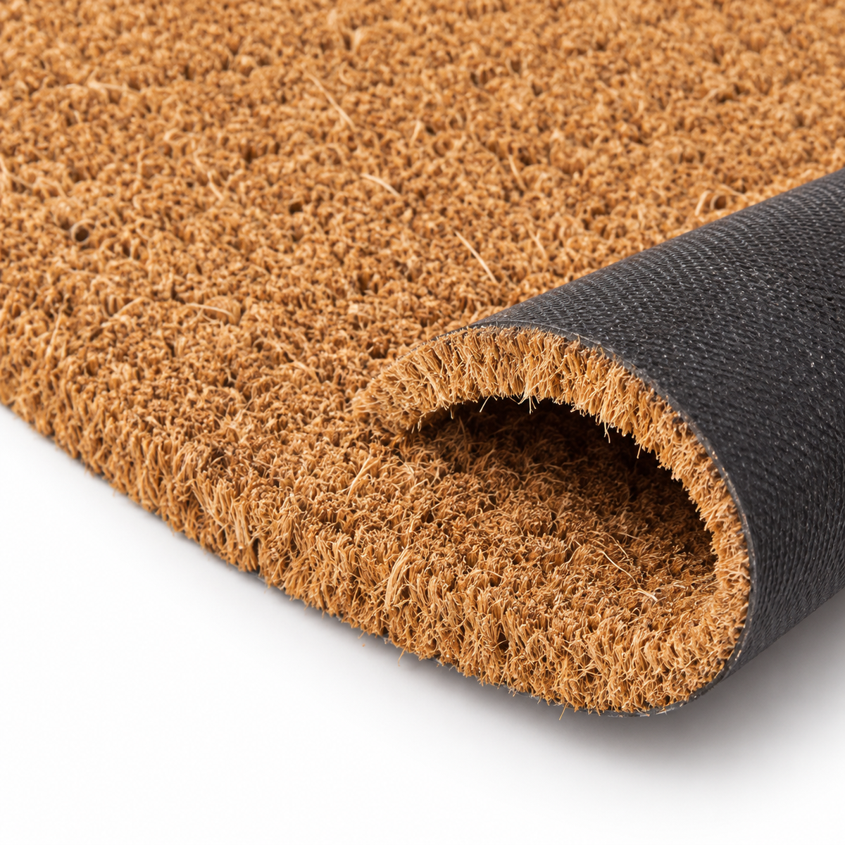 A close-up of a brown coir doormat with a black textured underside, shown partially rolled to reveal the backing on a white background.
