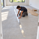 Janser steel straight edge laid along a room centre for marking out an oak herringbone floor.