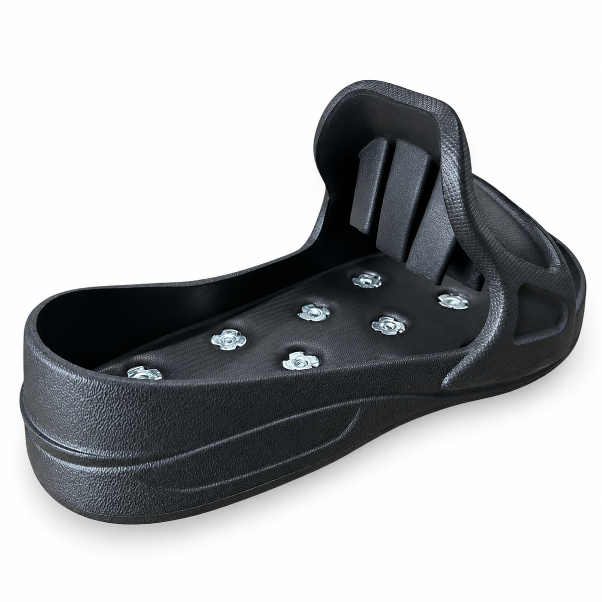 Angled view of a black spiked overshoe showing its moulded footbed and instep bridge