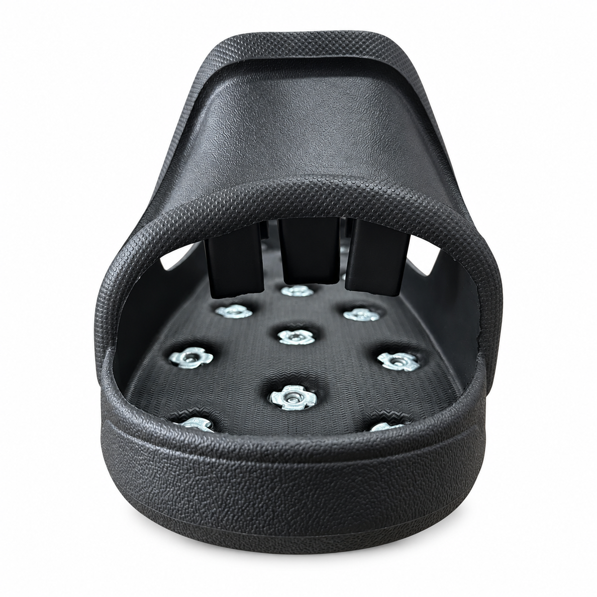 Front detail of a slip-on spiked overshoe showing the textured bridge and internal fixings