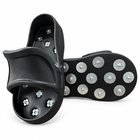 Pair of black slip-on spiked overshoes showing the upper and metal-spiked underside